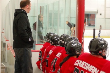 Our esteemed coach Austin Lindstrom looks on from behind the bench.