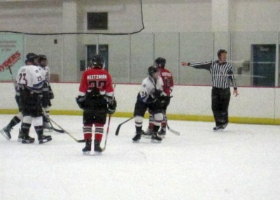 The ref tries to figure out the faceoff placement.