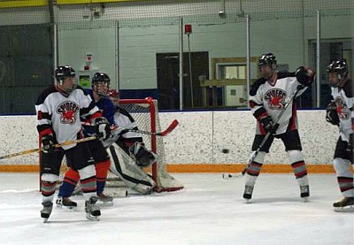 Chris Stalpes (21) clears the puck.