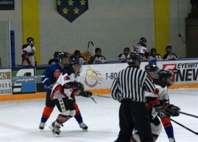 Bruce Gustafson (10) wins the draw at center ice.