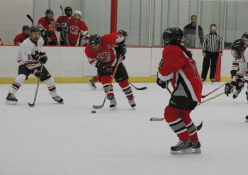 Right wing Bob “Bobby” Jensen (5) threads the defense, while left wing Lu Kwan (17) waits for a pass.