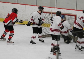 Center John Rajes (8) tries to bang one through a wall of Outlaws.