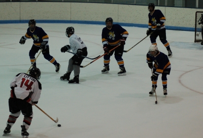 Defenseman Jeremy Litton (14) faces a wall of Fighting Saints, while new Spider Brian Armagost (77) moves to the slot, in the Oct. 13 game vs. the Fighting Saints.