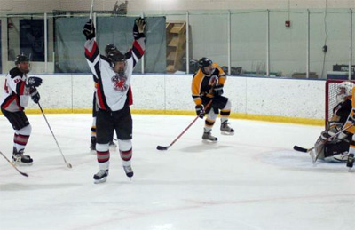 Brad Caron (23) celebrates his first-period goal.