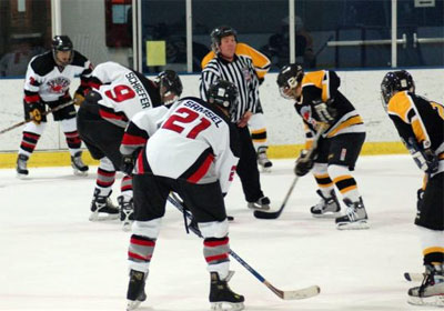 Mark Franklin (7), Dave Schaefer (9) and Ted Samsel (21) line up for a faceoff.