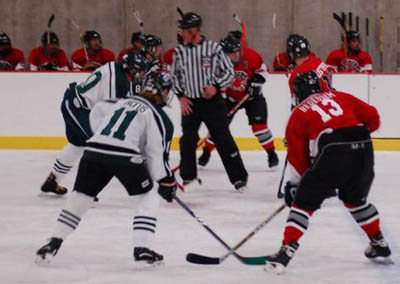 Aaron Bedessem (13), Bruce Gustafson (10) and Marc Berris (18) line up for a faceoff.