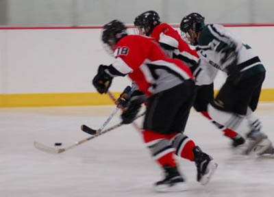 Marc Berris (18) and Carlos Eberhardt (11) give the squeeze on a Wolf Pack attacker.