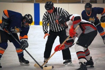 Chris Flannery (12) faces off against the Fighting Saints.