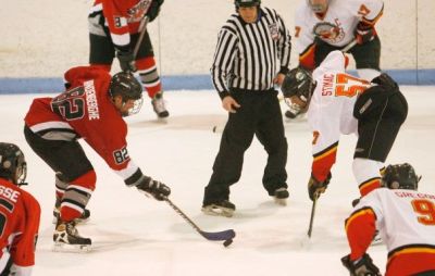 Cory Vandenberghe (82) draws the faceoff to Paul LaCosse (26), with Mike Armel (3) watching.