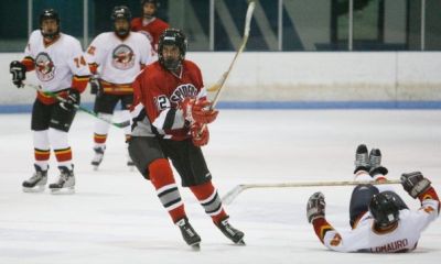 Chris Flannery (12) skates by a fallen Jack.