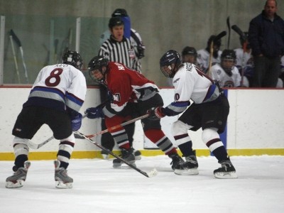 Defenseman Jay Hilden (7), under the watchful eye of the ref and Wingmen Coach Little.