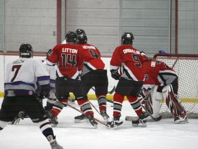 A scrum down low, with Jeremy Litton (14), Ryan Herman (4) and Rob Droullard (9) practicing the Wall of D.