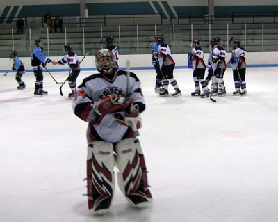 The winning goaltender, carries the commemorative game puck.