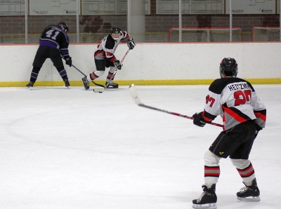 Johnson (38) lines up a one-timer to Heitzman (27) in the zone.